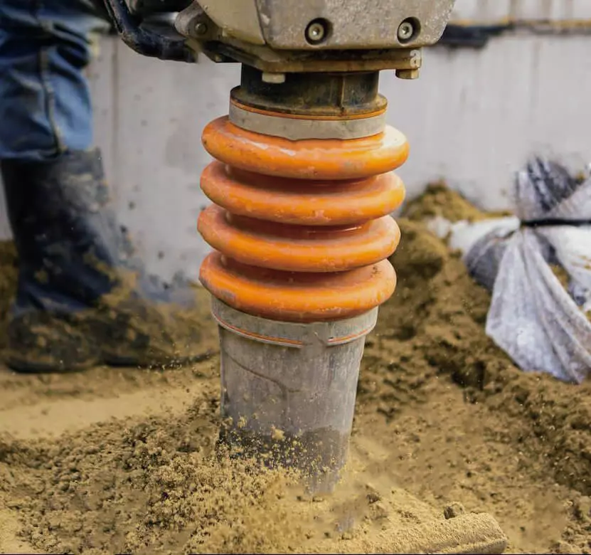 One man operates earth rammer to tamp the ground.jpg